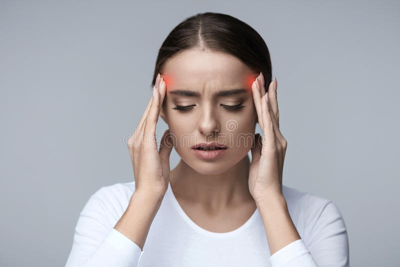 Woman holding sides of her head